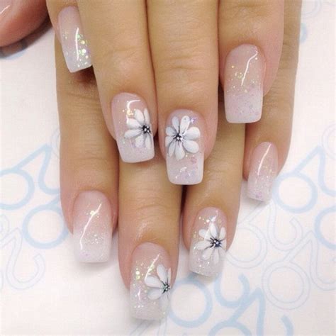 white nails with black flowers|clear nails with white flowers.